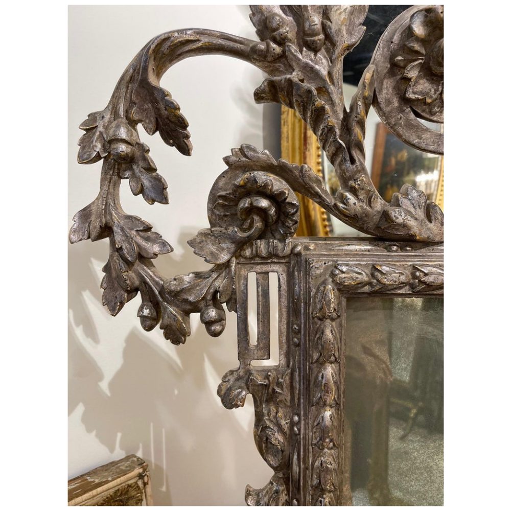 Antique wood frame with carved leaf design and a silver outlet wood carved liner of which looks like a four leaf clover.